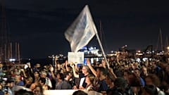 Protestors show up with arancini to show support for stranded migrants 