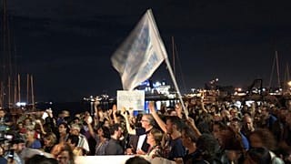 Protestors show up with arancini to show support for stranded migrants 