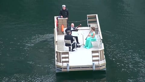 Watch: Orchestra players perform on water 