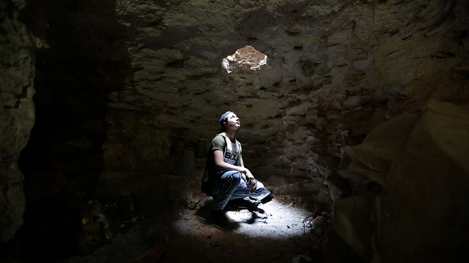 A man takes shelter in an underground cave in Idlib, Syria