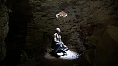 A man takes shelter in an underground cave in Idlib, Syria