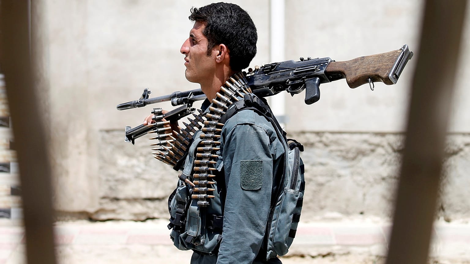 An Afghan policeman keeps watch during a battle with insurgents in Kabul.