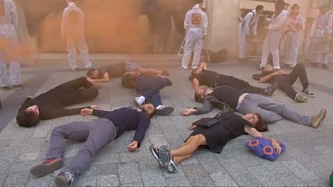 Activists mark anniversary of 2008 financial crisis with protest outside Paris bank