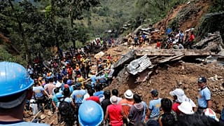 Rescuers in Itogon municipality, Philippines at the site of a landslide