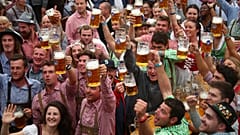Visitors cheer during the opening day of the 185th Oktoberfest in Munich
