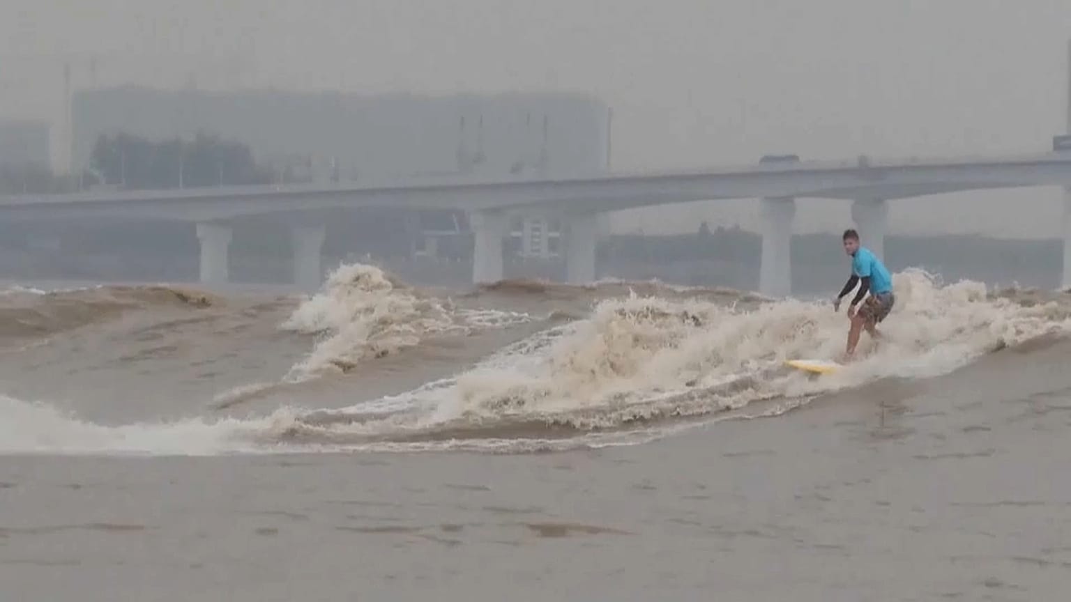 Surfers from around the world gather to ride tidal bores of the Qiantang River