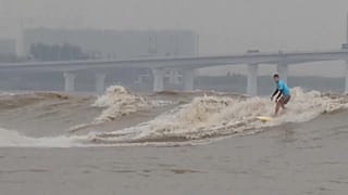 Surfers from around the world gather to ride tidal bores of the Qiantang River