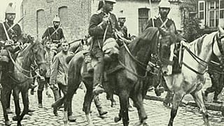 French cavalry marching German prisoners through the town of Aniche.