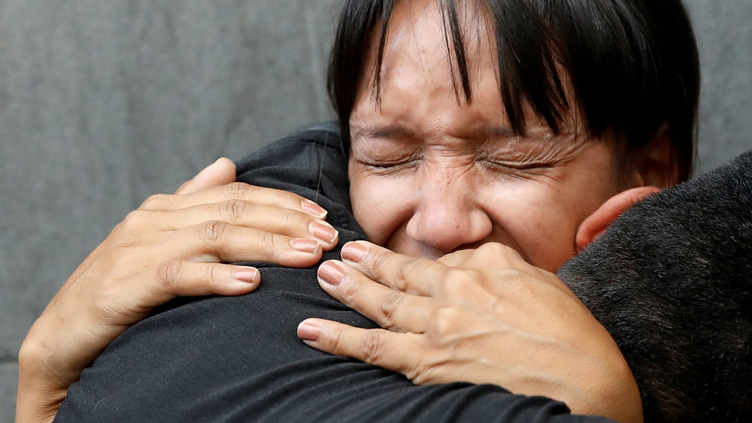 Mourners react outside National Intelligence Service building in Caracas