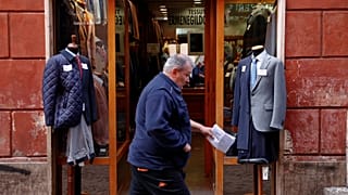 A man walks past a clothing shop in Rome, Italy October 22, 2018. 