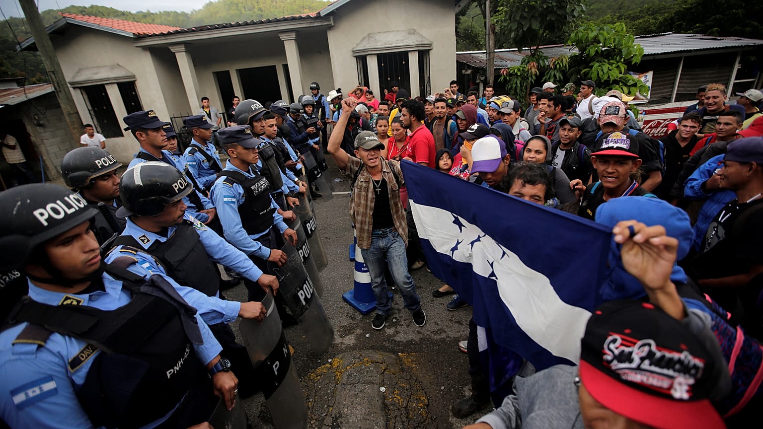 Migrants are confronted by police at the Honduras-Guatemala border