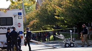 Police and a bomb disposal robot