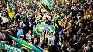 Supporters of Jair Bolsonaro react after Bolsonaro wins the presidential ra