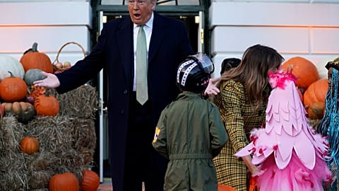 Donald and Melania Trump hand out Halloween sweets to children at White House