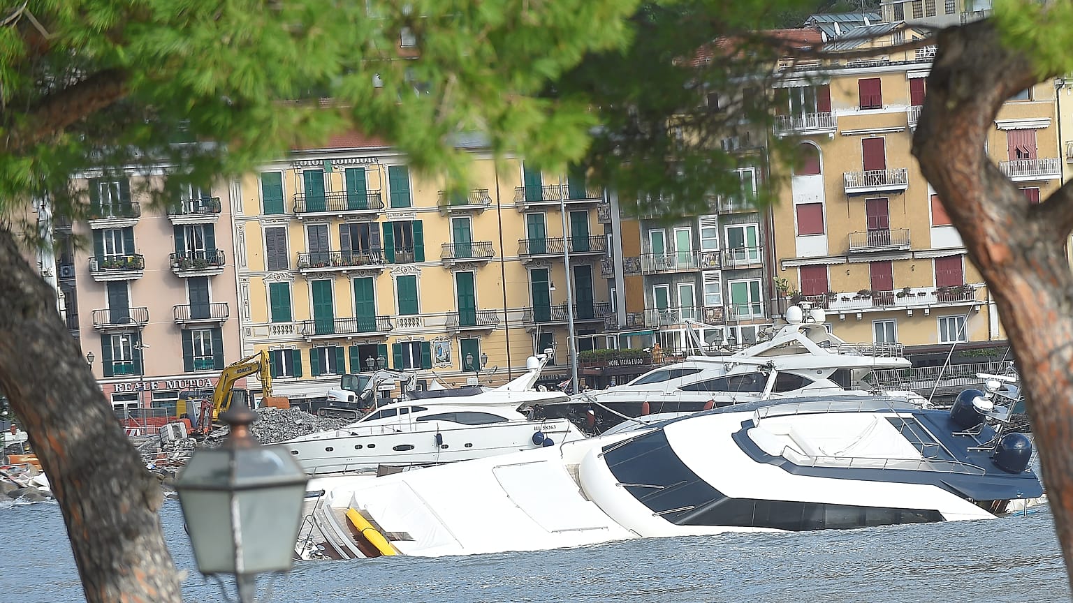 Semi-submerged yachts are seen in the harbour after windstorm and the stron