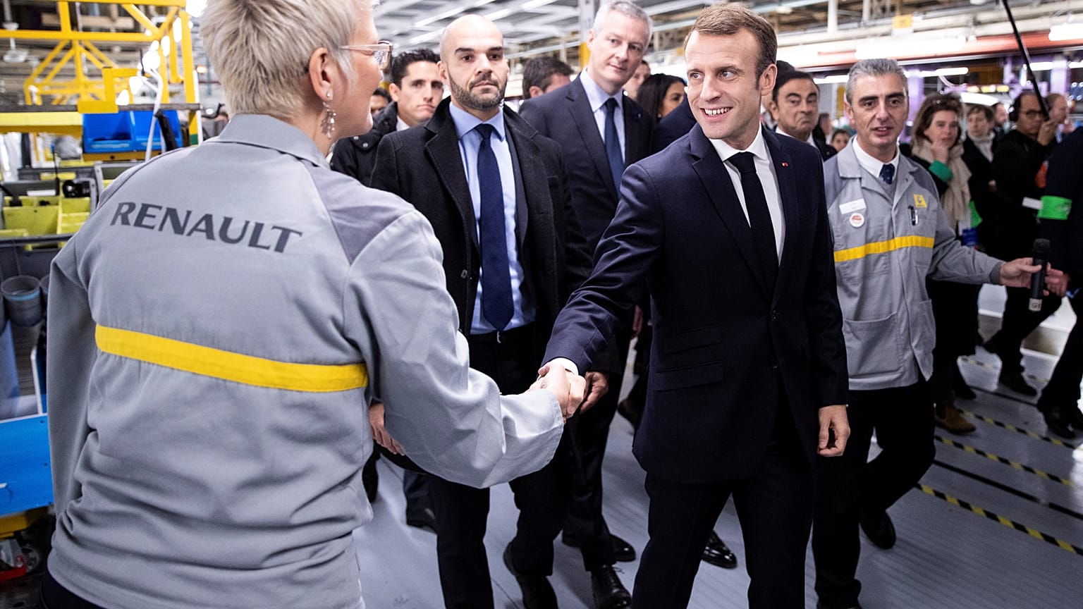 Macron defies hecklers