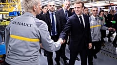 Macron defies hecklers