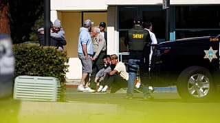 Mourners react outside a reception centre for families of victims of a mass