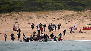 Migrants on Del Canuelo beach, after they crossed the Strait of Gibraltar