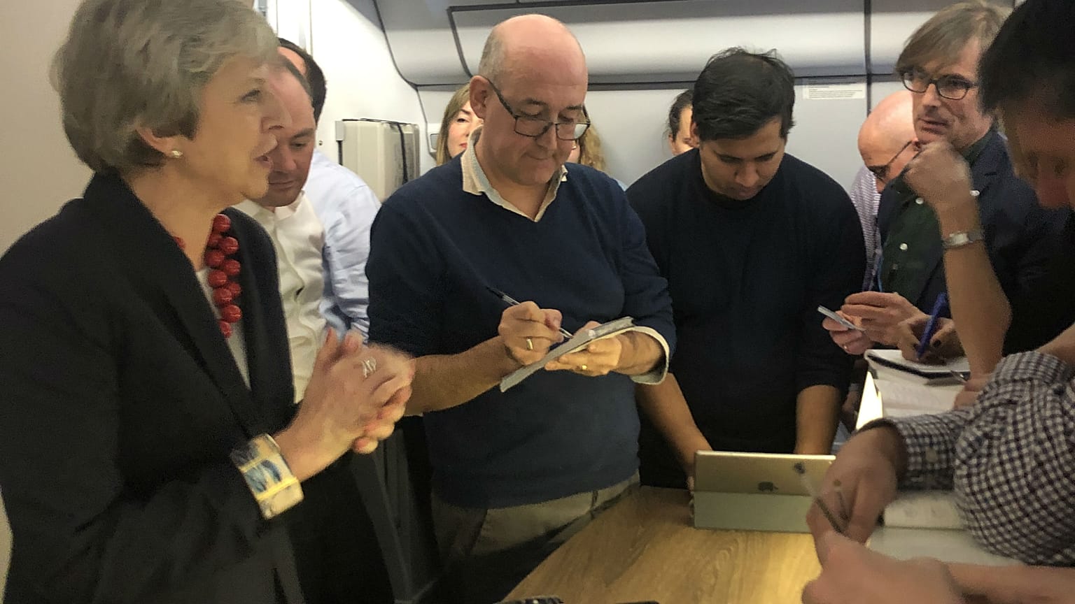 Theresa May gives a press conference on board her plane