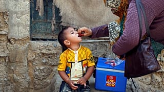 Boy receives polio vaccine drops, Karachi, Pakistan April 9, 2018.