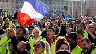 People wearing yellow vests, a symbol of a French drivers' protest against