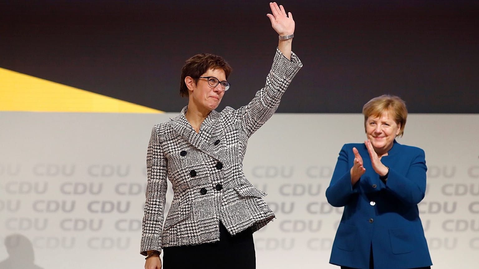 Annegret Kramp-Karrenbauer waves to CDU delegates after her election.