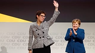 Annegret Kramp-Karrenbauer waves to CDU delegates after her election.