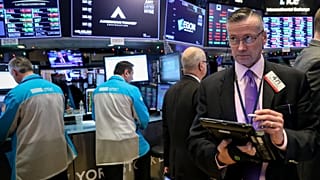 Traders work on the floor of the NYSE in New York
