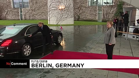 British PM Theresa May locked in car as she meets Angela Merkel