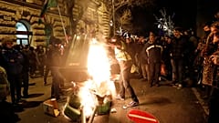Prostesters against the new "slave law" burn bins in front of parliament
