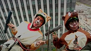 Cleaners dressed as zodiac animals clean hotel windows in Japan