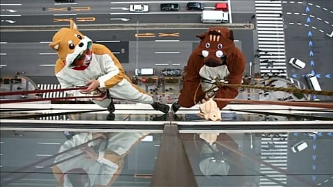 Cleaners dressed as zodiac animals clean hotel windows in Japan
