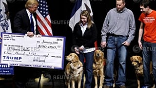 Donald Trump presents a mock check from the Trump Foundation 