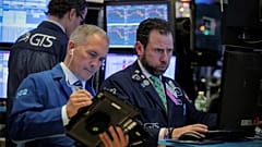 Traders work on the floor of the NYSE in New York