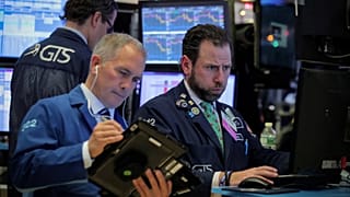 Traders work on the floor of the NYSE in New York
