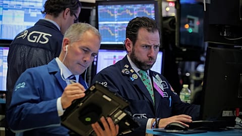 Traders work on the floor of the NYSE in New York