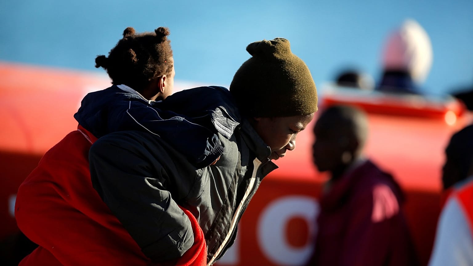 A migrant woman and her child safely disembark in Malaga.