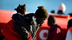 A migrant woman and her child safely disembark in Malaga.