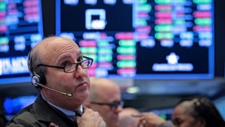 Traders work on the floor of the NYSE in New York