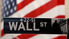 A Wall Street sign is seen outside the New York Stock Exchange