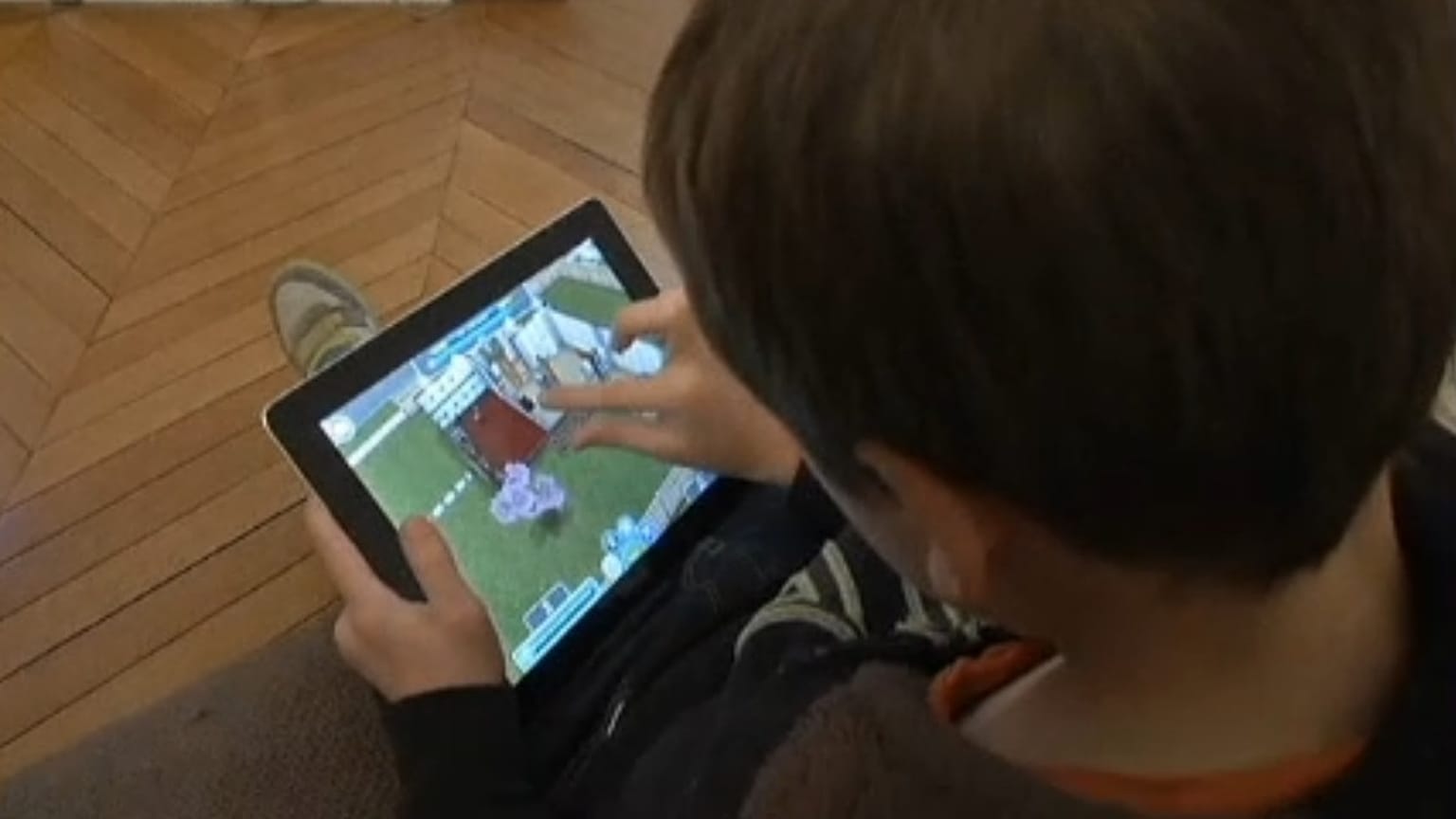 A child watching a screen.