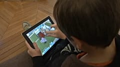 A child watching a screen.