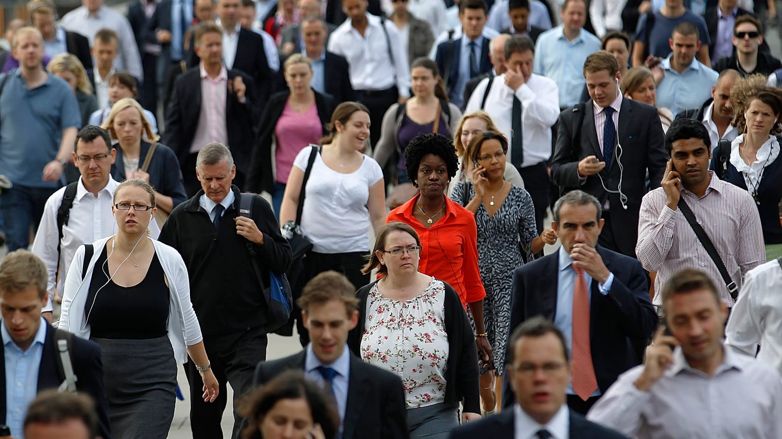 Commuters walk across London Bridge to the City of London August 7, 2013. 