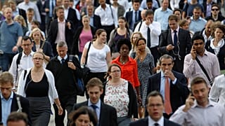 Commuters walk across London Bridge to the City of London August 7, 2013. 