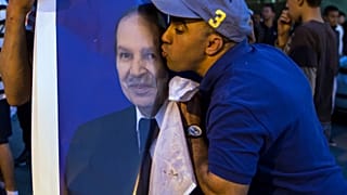 مواطن جزائري مؤيد للرئيس عبد العزيز بوتفليقة يقبل صورته، نيسان/2014