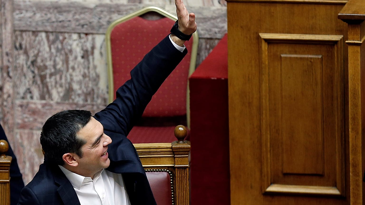Greek Prime Minister Alexis Tsipras votes during a parliamentary session on