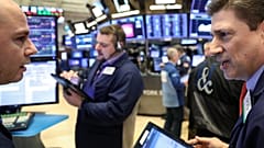 Traders work on the floor of the NYSE in New York