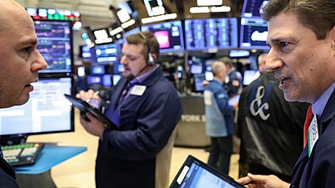 Traders work on the floor of the NYSE in New York