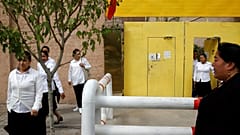 Ethnic Uighur women leave a centre in Xinjiang Uighur Autonomous Region